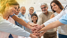 Group clasping hands together